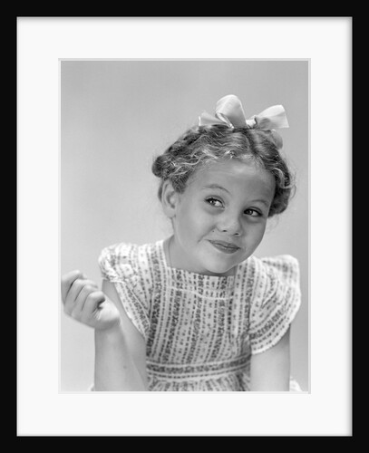 1940s little girl smiling smirking looking off to one side by Anonymous