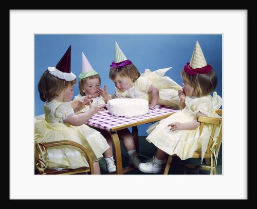 1950s 1960s quadruplets 4 red haired girls wearing party hats and dresses sitting table birthday cake by Anonymous