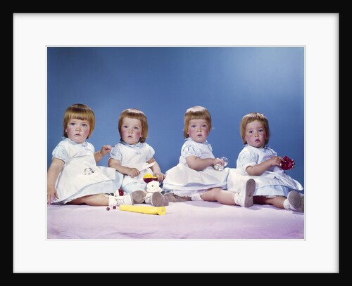 1950s 1960s portrait of quadruplets 4 red haired girls wearing dresses sitting in a row by Anonymous