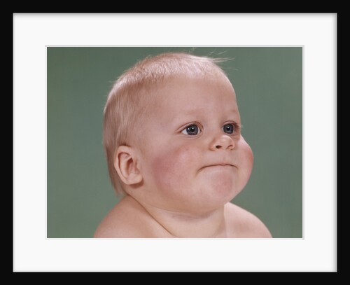 1960s portrait of blond baby chubby cheeks with funny face expression by Anonymous