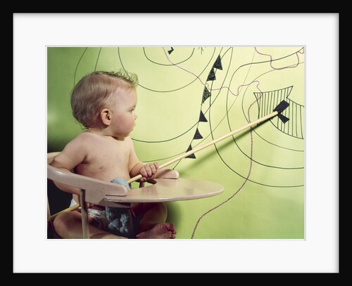 1960s baby in high chair using wooden pointer to indicate low pressure area on weather map by Anonymous