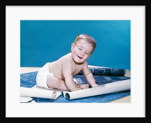1960s baby eyes closed funny facial expression crawling on rolling out blueprints by Anonymous