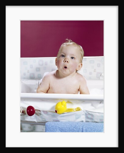 1960s baby in layette bath making funny face by Anonymous