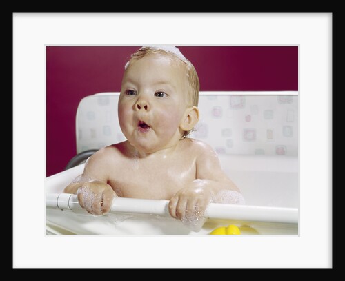 1960s wet baby in bath making funny face by Anonymous