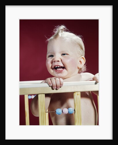 1960s laughing blond baby in crib or playpen by Anonymous