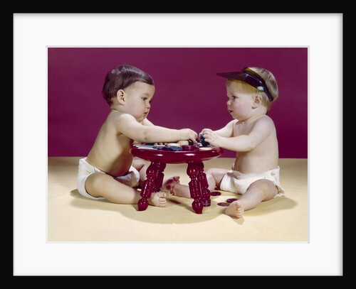 1960s two babies sitting at red stool playing cards poker with gambling chips by Anonymous
