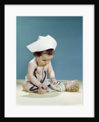 1960s baby wearing nurse nurse's cap stethoscope listening to doll heartbeat chest by Anonymous