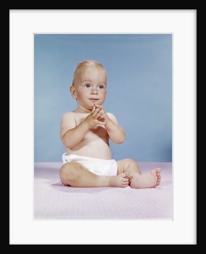 1960s baby wearing cloth diaper sitting with hands together thoughtful pose expression by Anonymous