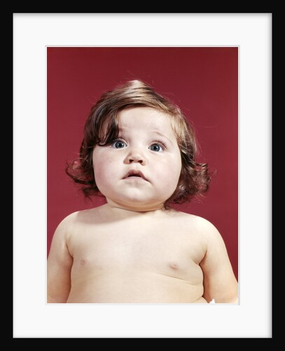 1960s portrait brunette baby girl with chubby round face uncertain facial expression looking at camera by Anonymous