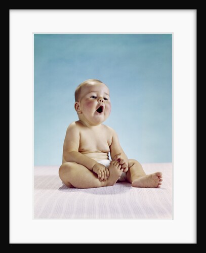 1960s tired baby sitting holding on to one foot yawning facial expression by Anonymous