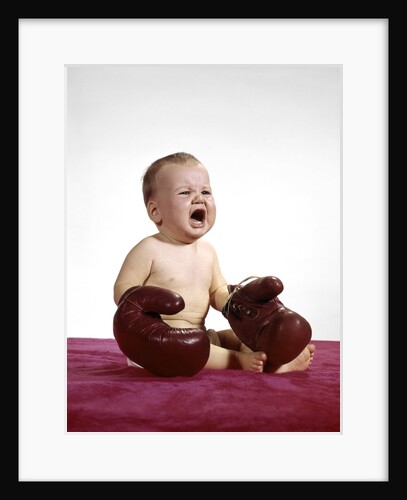 1960s crying baby wearing large boxing gloves by Anonymous