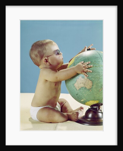 1960s baby wearing eyeglasses hugging the world globe earth by Anonymous