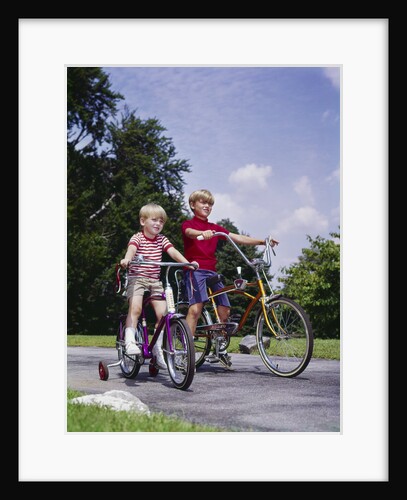 1970s 1960s two boys riding bikes in park summer by Anonymous