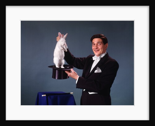 1960s 1970s man magician tuxedo pulling rabbit out of top hat magic illusion sleight of hand trick by Anonymous