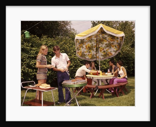 1970s group teenagers boys girls backyard grilling table umbrella by Anonymous