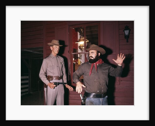 1960s 1970s western sheriff arrests bearded cowboy about to draw gun by Anonymous