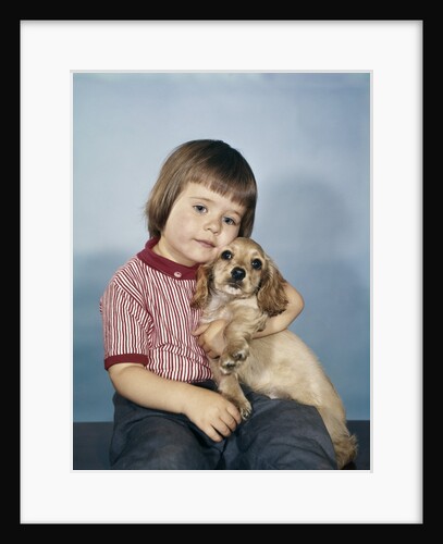1950s 1960s winsome sad little girl sitting hugging a cocker spaniel puppy studio by Anonymous