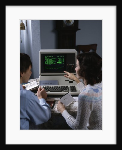 1980s couple working at apple iii 3 home computer paying bills by Anonymous