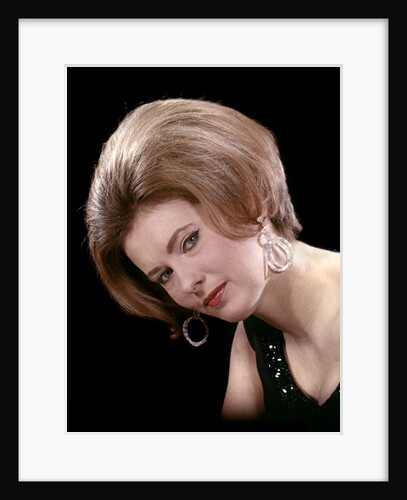 1960s portrait serious woman black sequin evening diamond earrings dress bouffant hairstyle looking at camera by Anonymous
