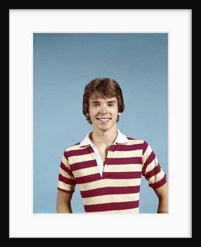 1970s portrait of smiling teenage boy wearing striped rugby shirt looking at camera by Anonymous