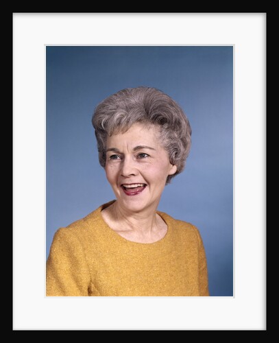 1960s portrait smiling elderly woman wearing orange top laughing looking to side by Anonymous