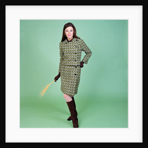 1960s young woman modeling green wool knit two piece suit fishnet stockings boots full length clothe by Anonymous