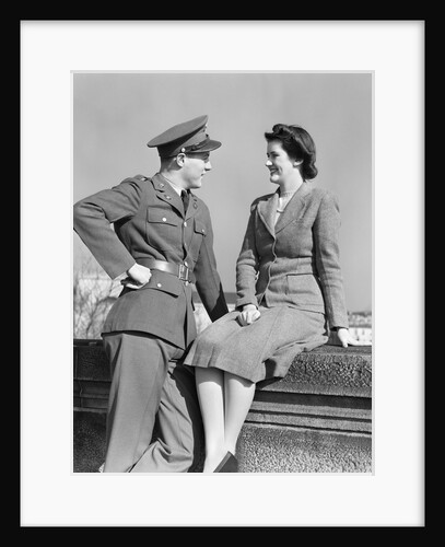 1940s happy couple man wearing army uniform woman sitting on stone wall by Anonymous