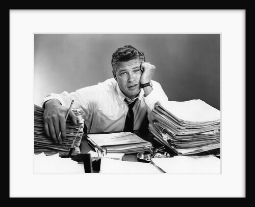 1950s portrait man overworked with desk full of papers by Anonymous