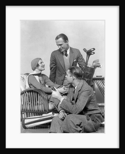 1930s two men one woman golf clubs bag smiling talking sitting bamboo chair man smoking pipe by Anonymous