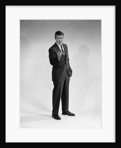 1960s man in business suit standing pointing finger looking at camera by Anonymous