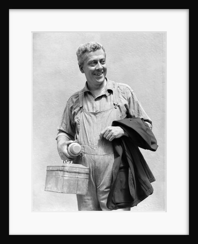 1930s man in overalls work uniform holding thermos lunchbox and jacket by Anonymous