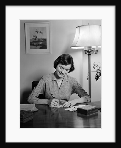 1940s 1950s woman sitting at desk writing letters doing correspondence by Anonymous