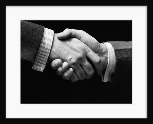 1930s close-up of businessmen's hands in handshake against dark background by Anonymous