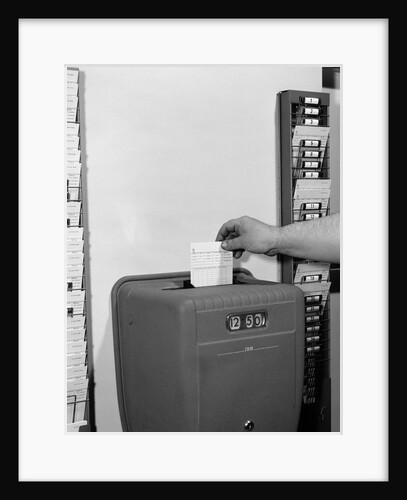 1950s man's hand punching time card by Anonymous