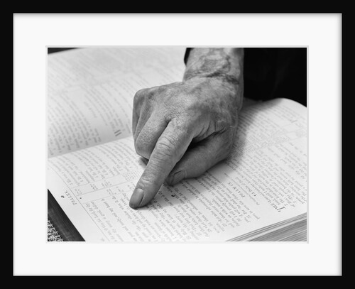 1940s hand of elderly man reading bible index finger following along passage by Anonymous