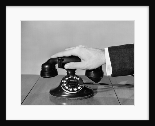 1930s 1940s man's hand on telephone by Anonymous