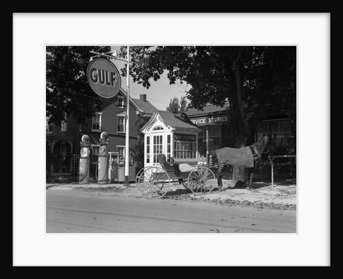 1930s horse & empty buggy tied to pole outside of gulf service station next to fancy wooden phone booth with shingled roof by Anonymous