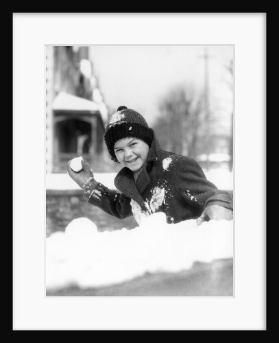 1920s 1930s smiling boy about to throw toss snowball playing snow fun winter cold mischief looking at camera by Anonymous