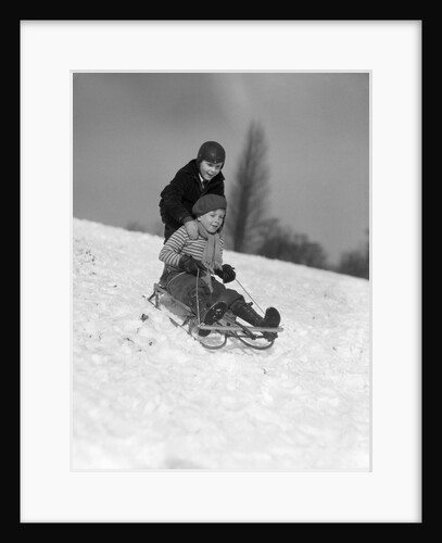 1930s two boys sledding outside in snow by Anonymous