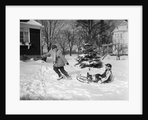 1950s woman mother pulling boy son on sled in winter by Anonymous
