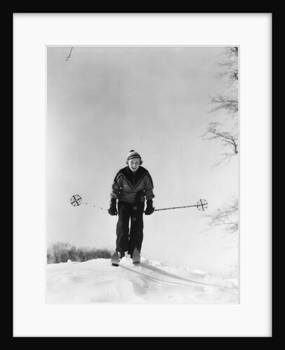 1930s woman holding ski poles skiing in snow by Anonymous