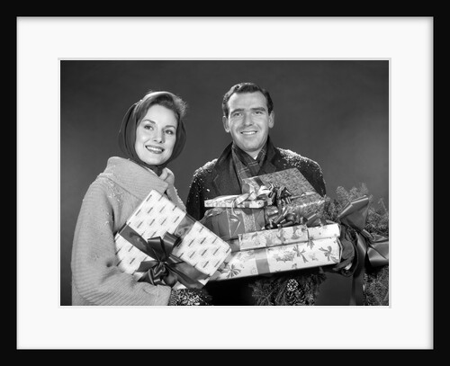 1960s smiling couple man and woman holding wrapped christmas presents and packages by Anonymous