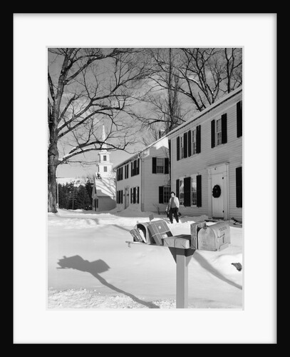 1960s woman walking to rural mailbox in front of home in snow piled with christmas packages by Anonymous