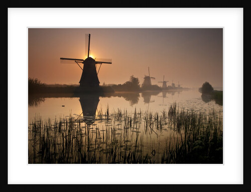 Sunset and silhouetted windmills reflected in the Canals Kinderdijk by Anonymous