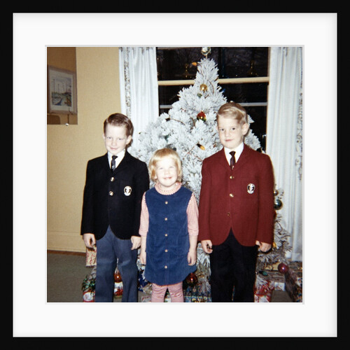 Dressed up siblings stand by the Christmas tree, ca. 1965. by Anonymous