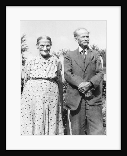 Grandma and Grandpa pose in the backyard, ca. 1955. by Anonymous