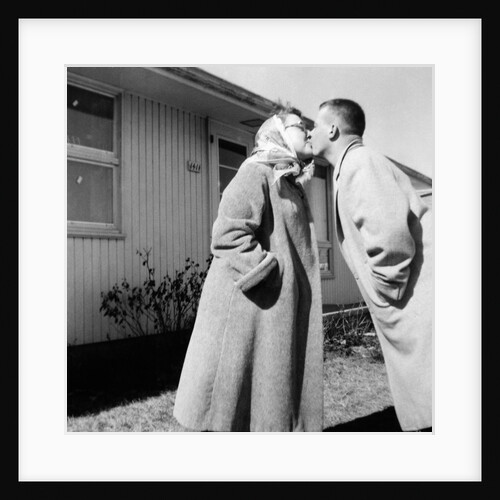 Young husband and wife kiss, ca. 1955. by Anonymous