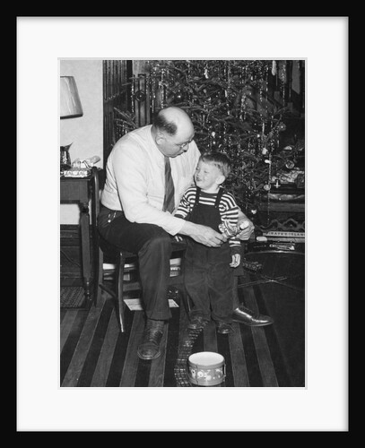 Father and son enjoy Christmas morning, ca. 1950 by Anonymous
