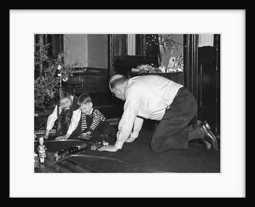 Dad plays with the kids on Christmas morning, ca. 1950 by Anonymous