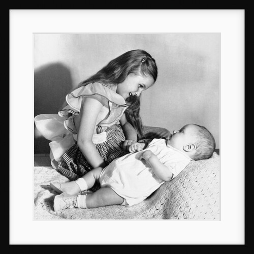 Big sister looks down on her baby brother, ca. 1948 by Anonymous